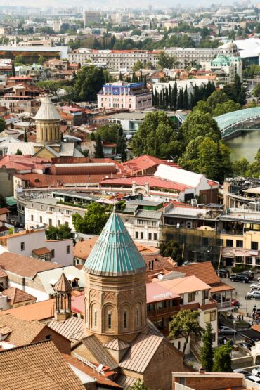 Panoramic cityscape showing church domes, tiled roofs and historic Georgian architecture