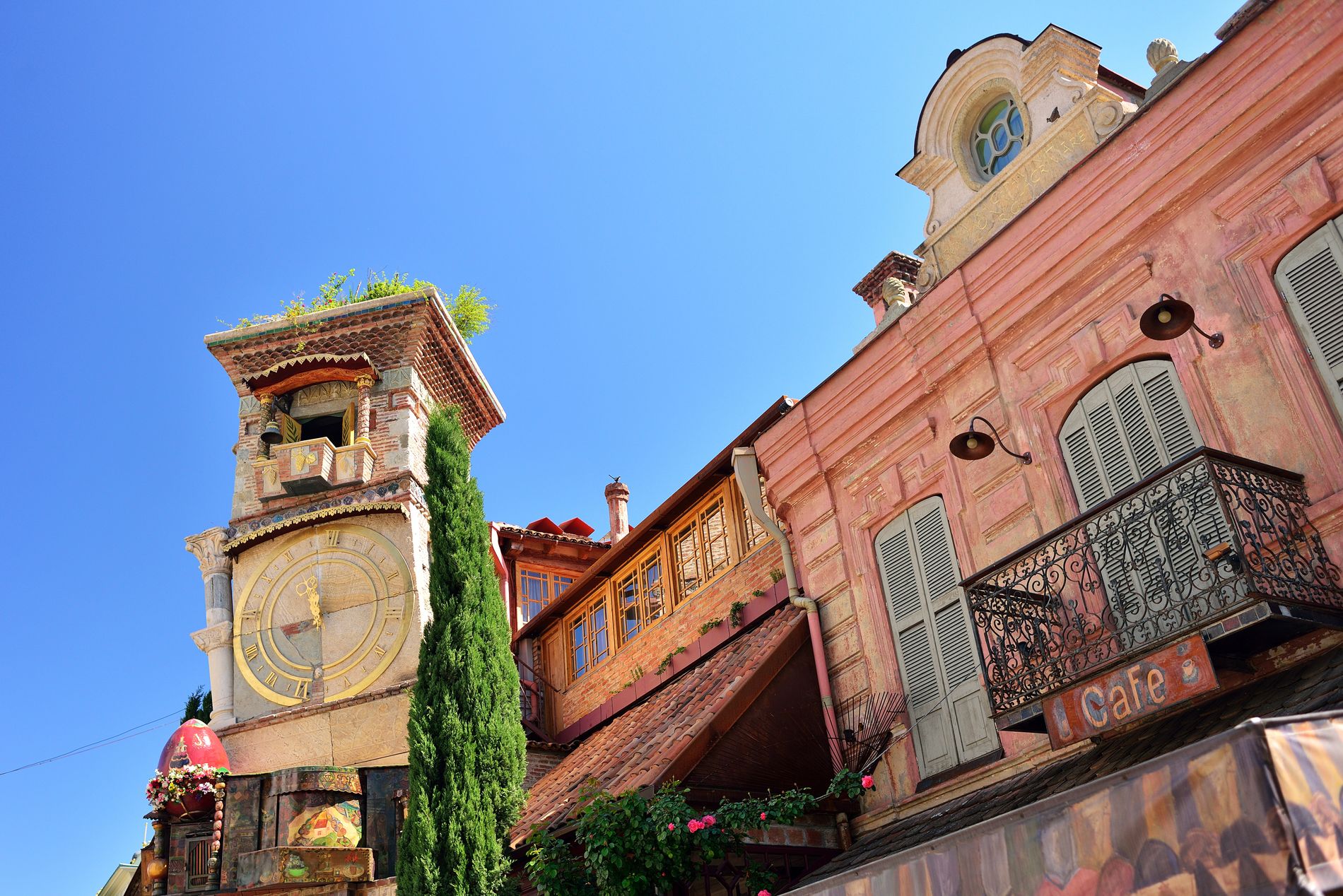 The leaning clock tower of Gabriadze Theater — fairytale-like structure with mosaic tiles and a mechanical puppet show