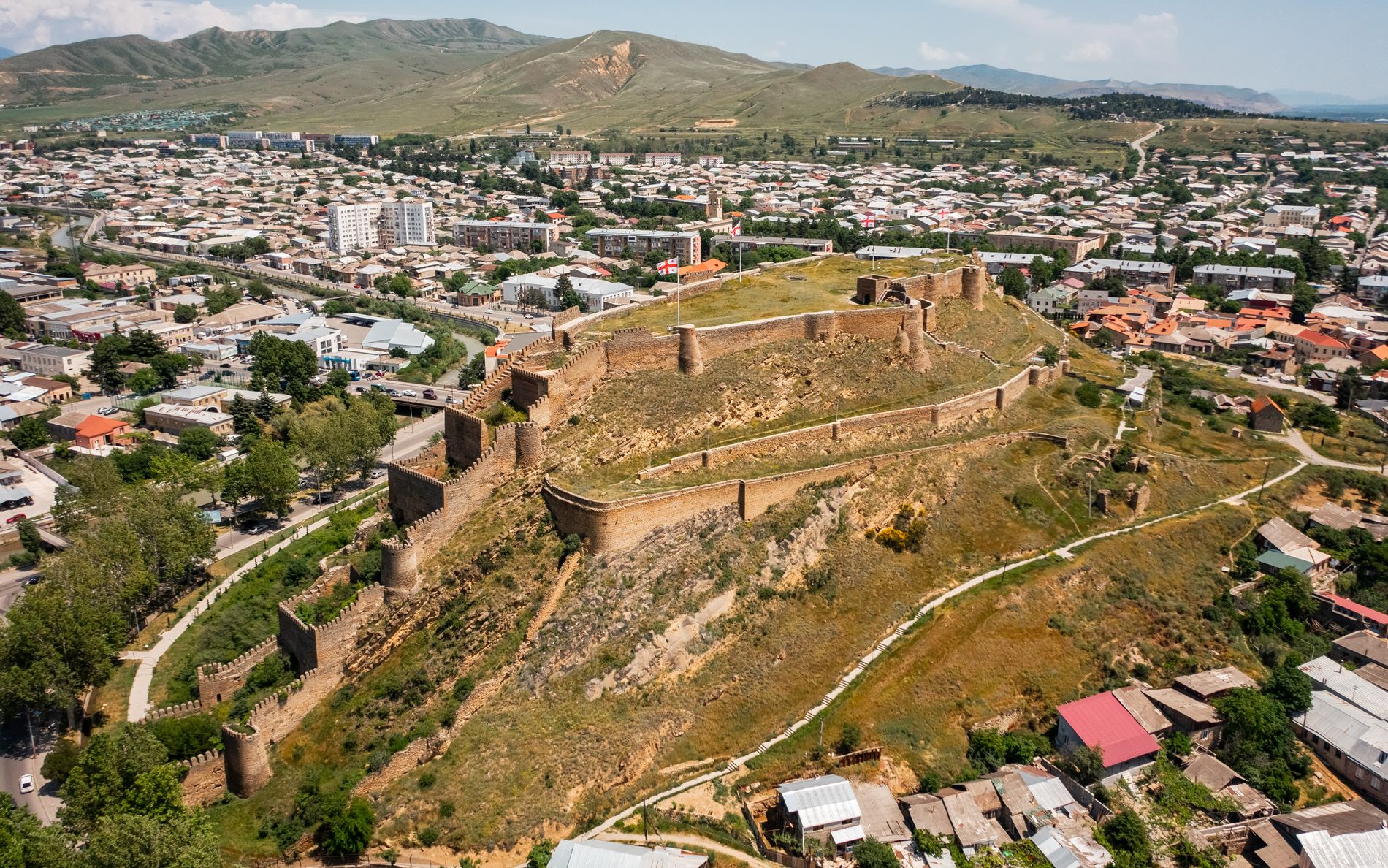 Aerial view of Gori Fortress — medieval stronghold on a hilltop with panoramic views of the city of Gori and surrounding valley