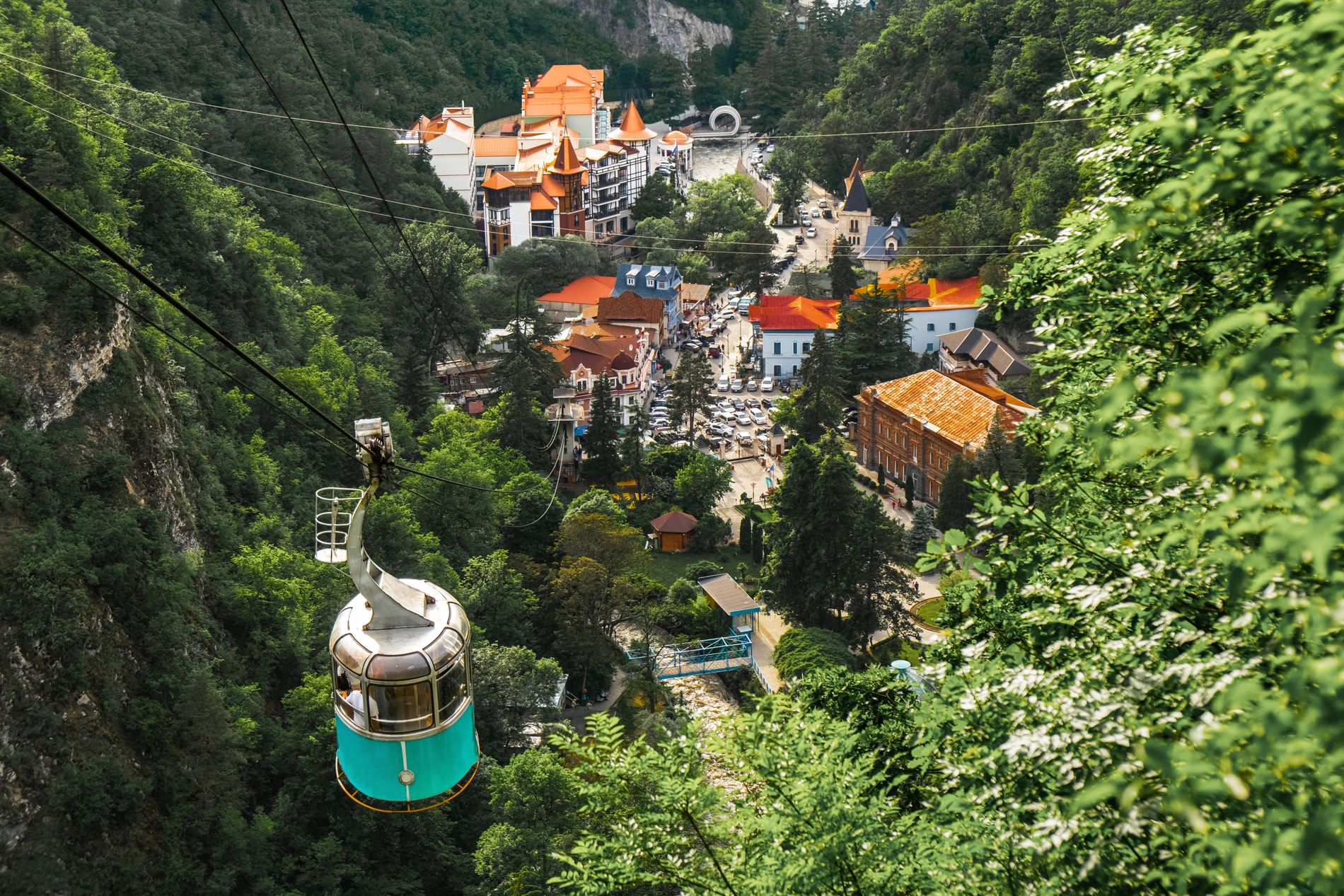 View from the cable car in Borjomi Central Park — lush forests, green hills and rooftops of Georgia’s most famous spa resort