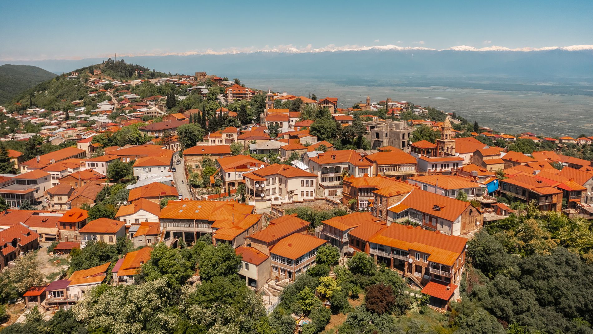 Red-tiled rooftops and traditional balconies in Sighnaghi — charming Georgian architecture on the hillside above the valley
