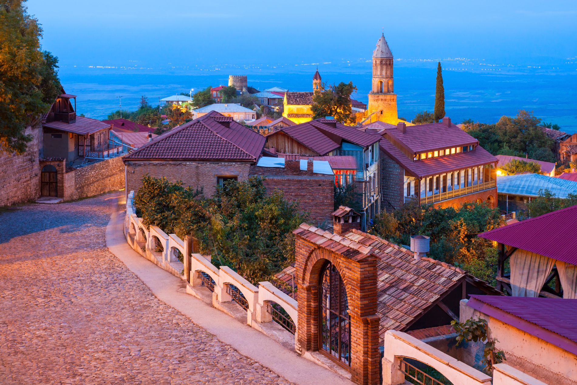 Evening view of Sighnaghi with glowing street lamps and moody sky — romantic atmosphere in the "city of love" in Georgia