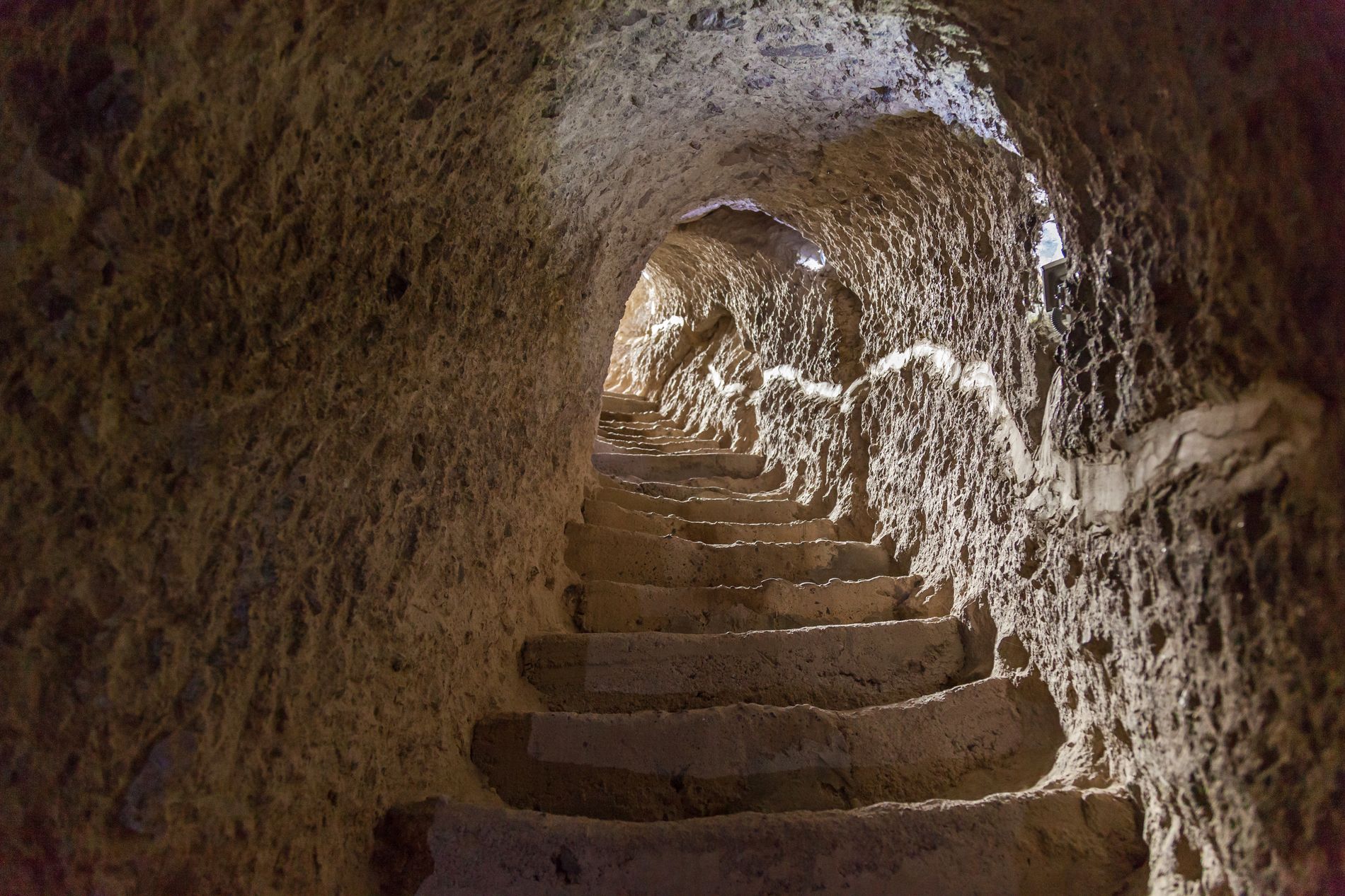 Narrow stairway carved into rock inside Vardzia — access between chambers of the ancient monastery in southern Georgia
