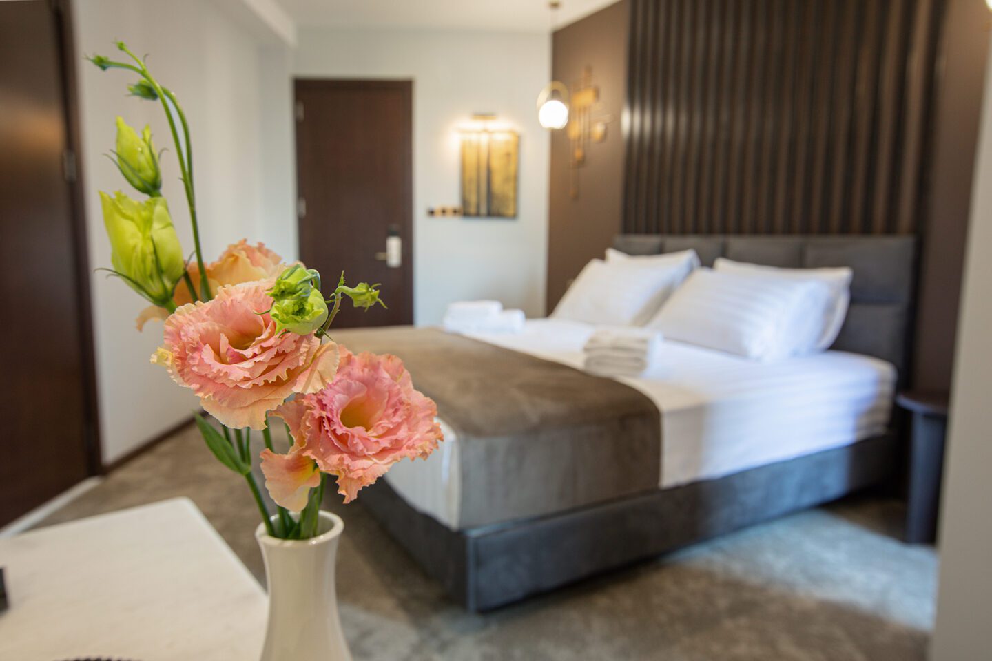 Warm and minimal interior of a deluxe hotel room in Tbilisi — fresh flowers, soft colors and relaxed atmosphere at Bellevue