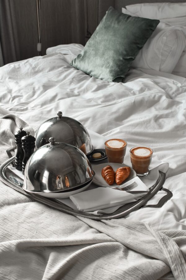 Elegant room-service breakfast — cozy atmosphere, white linens and natural light in a boutique Tbilisi hotel room