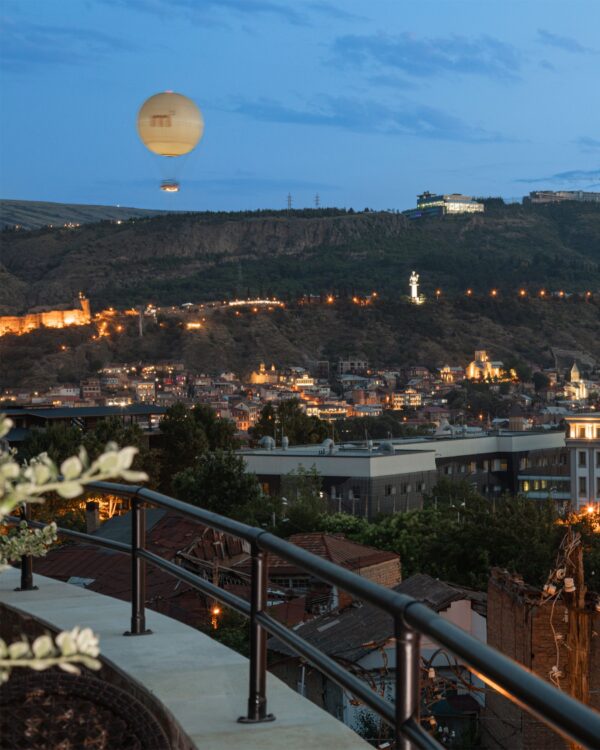 Panoramic terrace view of Tbilisi hills and the Mother of Georgia monument — one of the city’s iconic sights